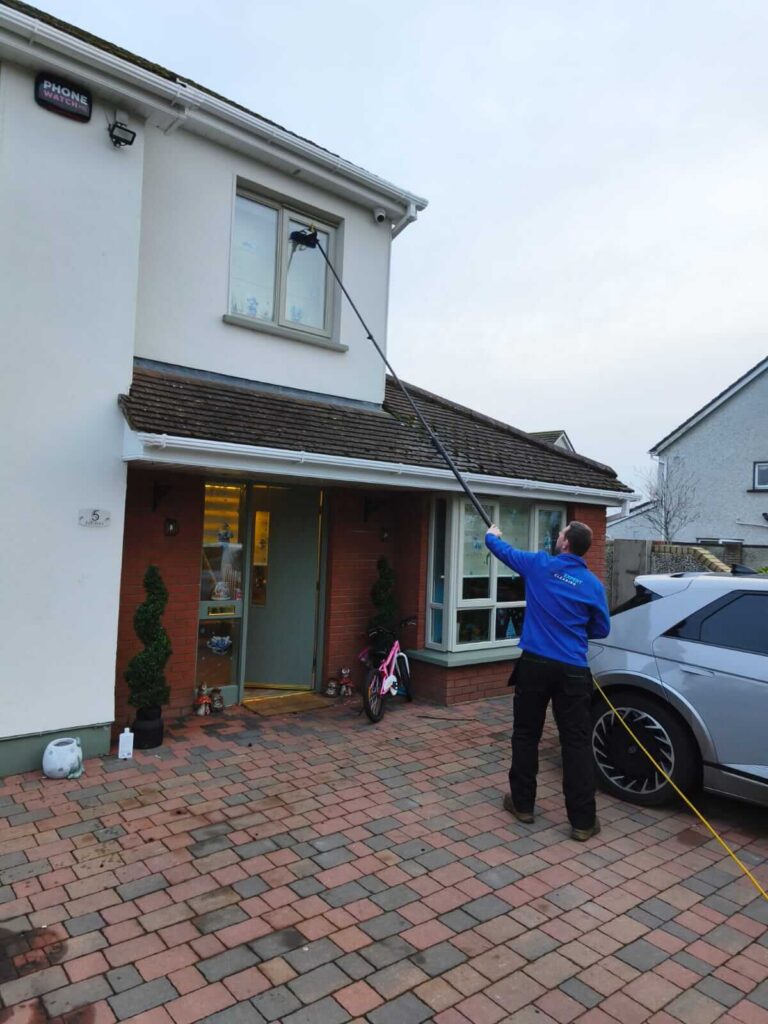 cleaning windows with a water fed pole